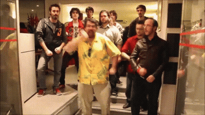 Man In Yellow Shirt Dancing With People GIF