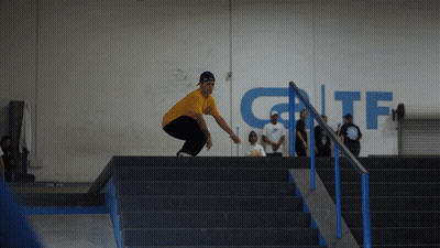 Man In Yellow Shirt Doing Trick On Stairs With GTF Sign GIF