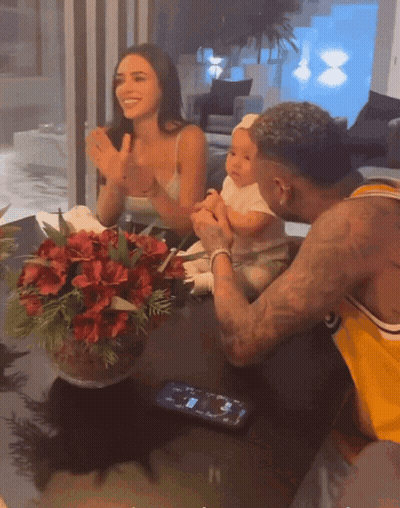 Man In Yellow Shirt Holding Baby While Woman Applauds GIF