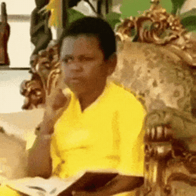 Man In Yellow Shirt Holding Book GIF