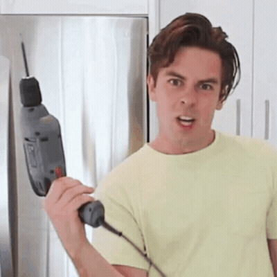 Man In Yellow Shirt Holding Drill GIF