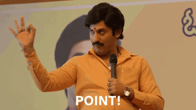 Man In Yellow Shirt Holding Microphone Saying Point GIF