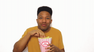 Man In Yellow Shirt Holding Popcorn GIF