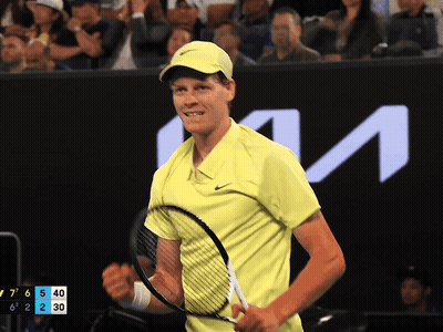 Man In Yellow Shirt Holding Tennis Racquet KTM Sign GIF