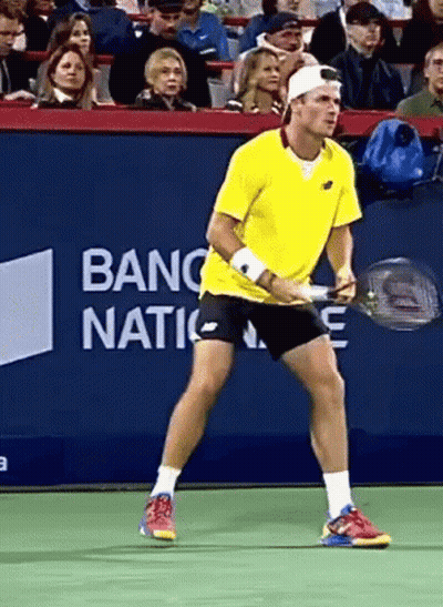 Man In Yellow Shirt Holding Tennis Racquet With Banc Nation Banner GIF