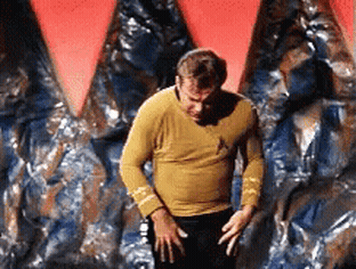 Man In Yellow Shirt In Front Of Red And Blue Wall GIF