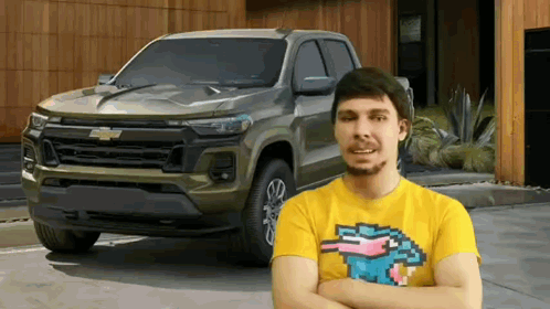 Man In Yellow Shirt In Front Of Truck Arms Crossed GIF