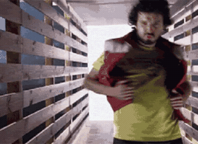 Man In Yellow Shirt In Wooden Hallway GIF