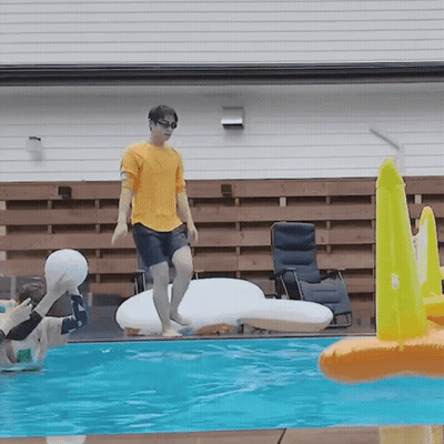 Man In Yellow Shirt Jumping Into Pool GIF