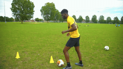 Man In Yellow Shirt Kicking Soccer Ball GIF