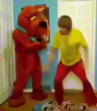 Man in Yellow Shirt Next to Red Teddy Bear