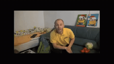 Man In Yellow Shirt On Couch With Two Minion Pictures GIF