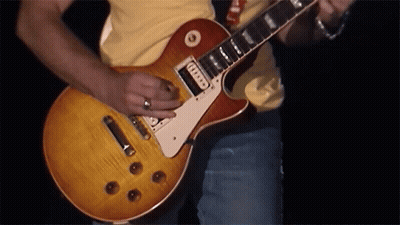 Man In Yellow Shirt Playing Guitar With Fender Sticker GIF