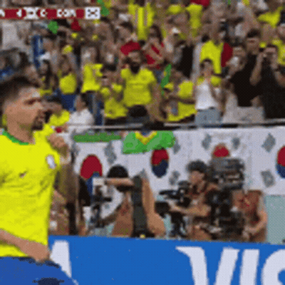 Man In Yellow Shirt Running Past Vic Sign GIF