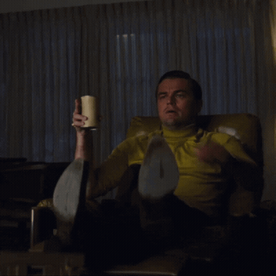 Man in Yellow Shirt Sitting and Pointing