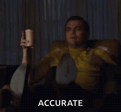 Man In Yellow Shirt Sitting On Couch Holding Cup And Pointing GIF