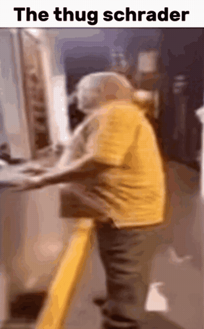 Man In Yellow Shirt Standing At Computer Captioned The Thug Schrader GIF