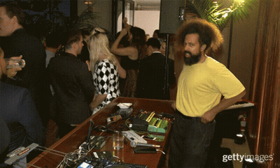 Man In Yellow Shirt Standing At Keyboard With Crowd GIF