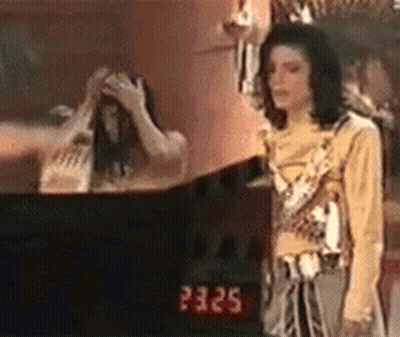 Man In Yellow Shirt Standing At Mirror GIF
