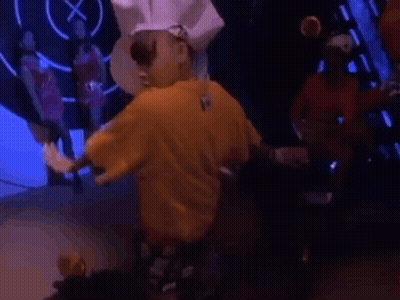 Man In Yellow Shirt Standing Before Crowd GIF