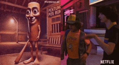 Man In Yellow Shirt Standing In Front Of Netflix Sign GIF