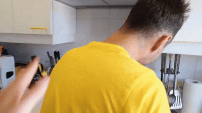 Man In Yellow Shirt Standing In Kitchen GIF