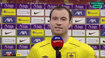 Man In Yellow Shirt Talking Into Microphone GIF