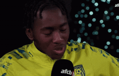 Man In Yellow Shirt Talking Into Microphone GIF
