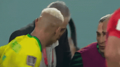 Man In Yellow Shirt Talking To Man In Green GIF