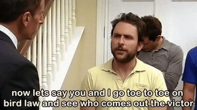 Man In Yellow Shirt Talking To Man In Suit While Another Watches GIF
