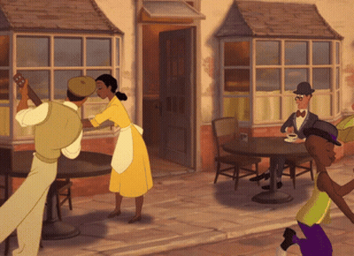 Man In Yellow Shirt Talking To Woman In Black Top GIF