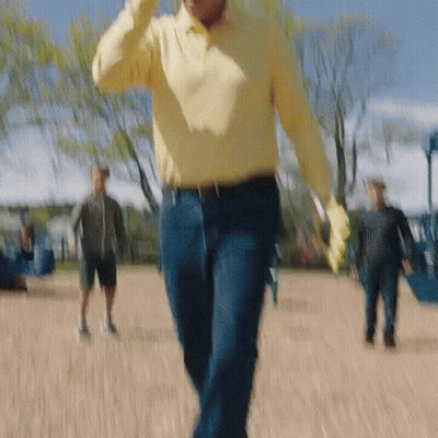 Man In Yellow Shirt Walking In Park GIF