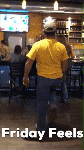 Man In Yellow Shirt Walking Through Restaurant GIF