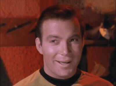 Man In Yellow Shirt With Black Collar Smiling GIF