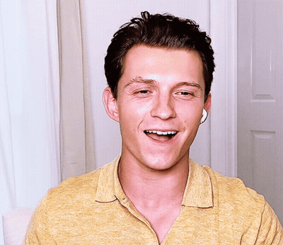 Man In Yellow Shirt With Earbuds Smiling Eyes Closed GIF