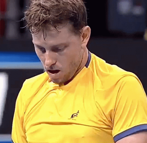 Man In Yellow Shirt With Kangaroo Looking Down GIF