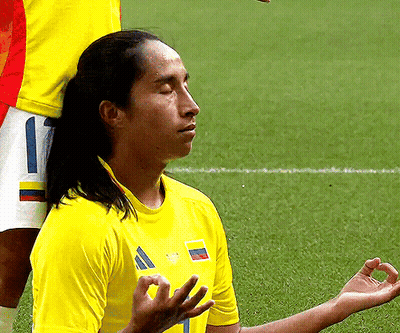 Man In Yellow Shirt With Number 1 Meditating GIF