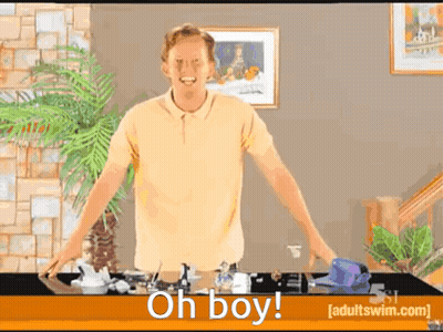 Man In Yellow Shirt With Oh Boy Table GIF