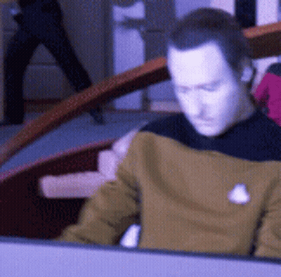 Man In Yellow Shirt With White Badge GIF
