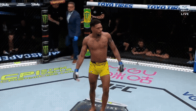 Man In Yellow Shorts In Boxing Ring With Toyo Tires GIF