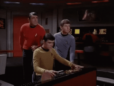 Man In Yellow Star Trek Shirt Using Computer GIF