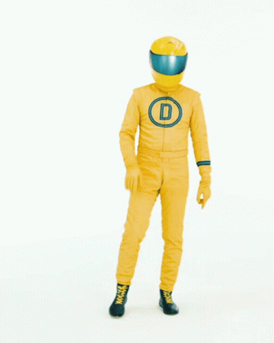 Man in Yellow Suit and Helmet in Front of Let's Talk Sign