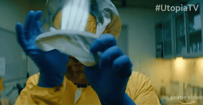 Man In Yellow Suit Holding Paper With Hashtag Utopiatv GIF