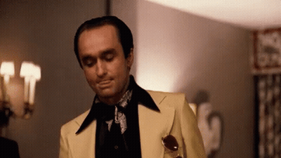 Man In Yellow Suit In Front Of Lamp GIF