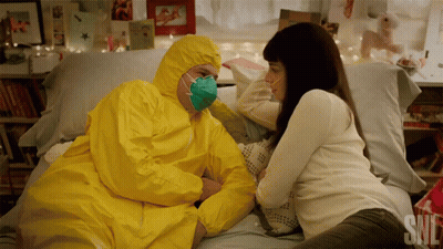 Man In Yellow Suit Lying On Bed GIF
