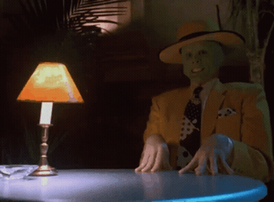 Man In Yellow Suit Sitting At Table GIF