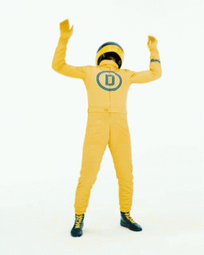 Man in Yellow Suit With Helmet in Front of Der War Gut Sign