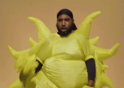 Man In Yellow Sun Costume Smiling GIF