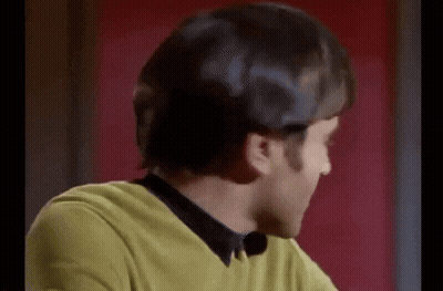 Man In Yellow Sweater And Black Shirt Smiling At Camera GIF