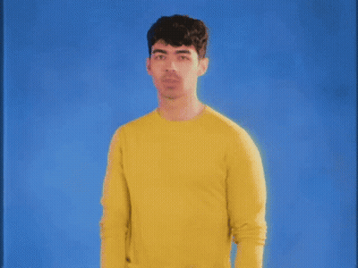 Man In Yellow Sweater Blue Background GIF